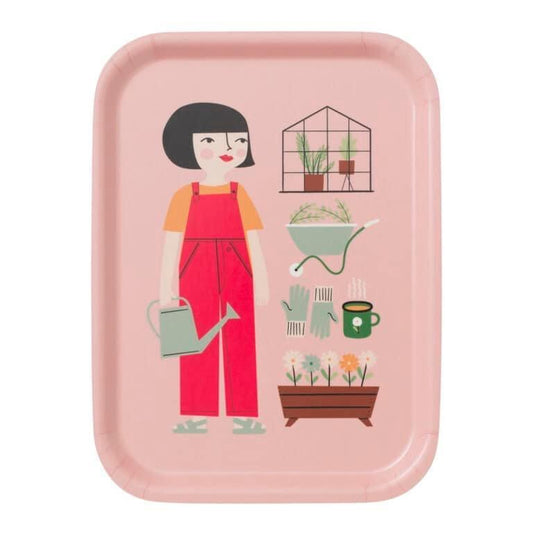 Illustration of a woman with black bobbed hair wearing red overalls and is holding a gray watering can. She is standing next to illustrations of several gardening things including a greenhouse, wheel barrow, flowers and gloves.