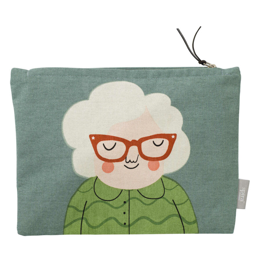 Green gray zipped toiletry bag with women's face with white hair, terra-cotta colored glasses and green shirt.