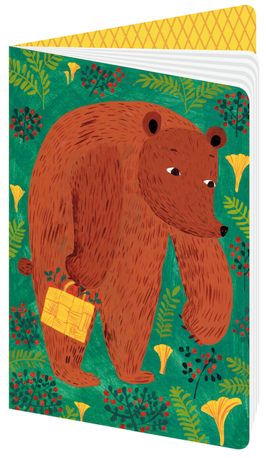 Notebook with illustration of a big reddish brown bear picking yellow chanterelles on a green woodland background.