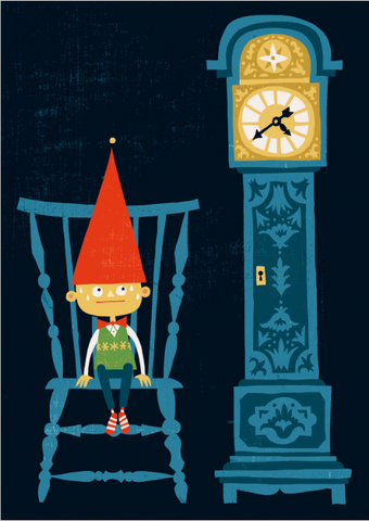 Little boy wearing a tall red elf hat sits in a blue chair next to a blue grandfather clock waiting for Santa Claus.