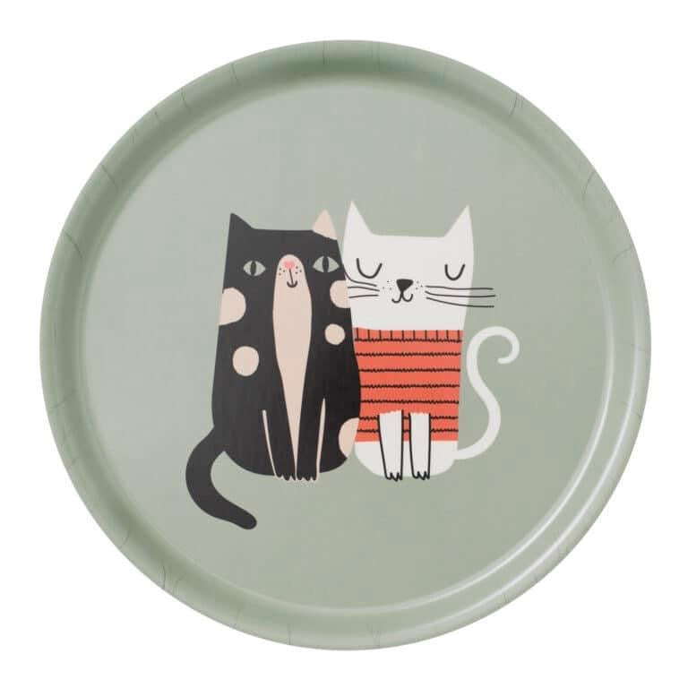 Illustration of two cats sitting next to each other on a solid gray green background. One cat is black with cream spots and gray green eyes. The second cat is all white and wears a salmon colored sweater with thin black stripes.