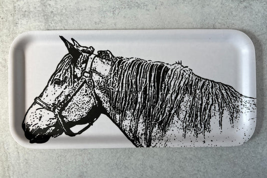White narrow long tray with a black and white image of a horse on a white background.